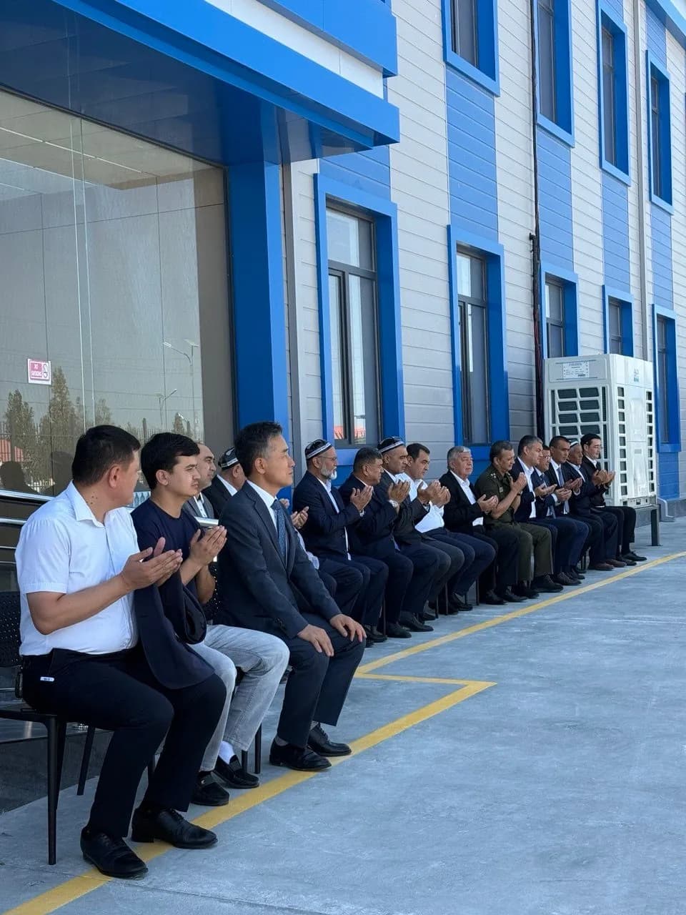 The official delegation and guests in the grounds of the new plant